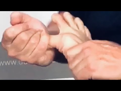 Deep foot massage using tools. Deep foot reflexology