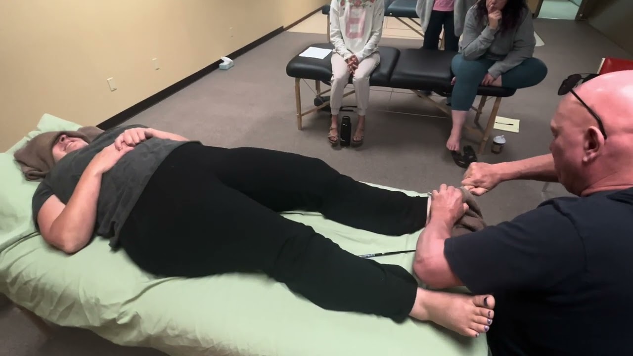 Deep tissue foot massage using tools and hands. Raynor massage therapy and reflexology.