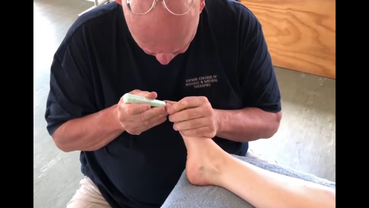 Foot reflexology massage using tools. Deep tissue foot massage. Brandon massaging Teresa in Tauranga