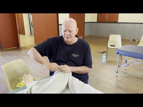 Foot reflexology massage and ankle adjustments. Moving trapped energy using foot adjustments.