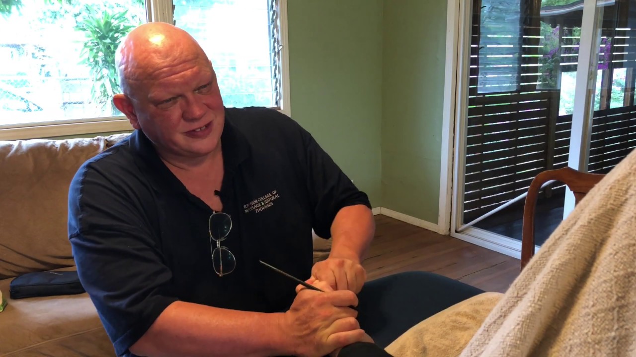 Foot reflexology. Foot massage with tools. Raynor massage discussion in Hawaii.
